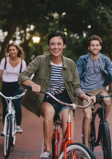 three friends riding on bicycles